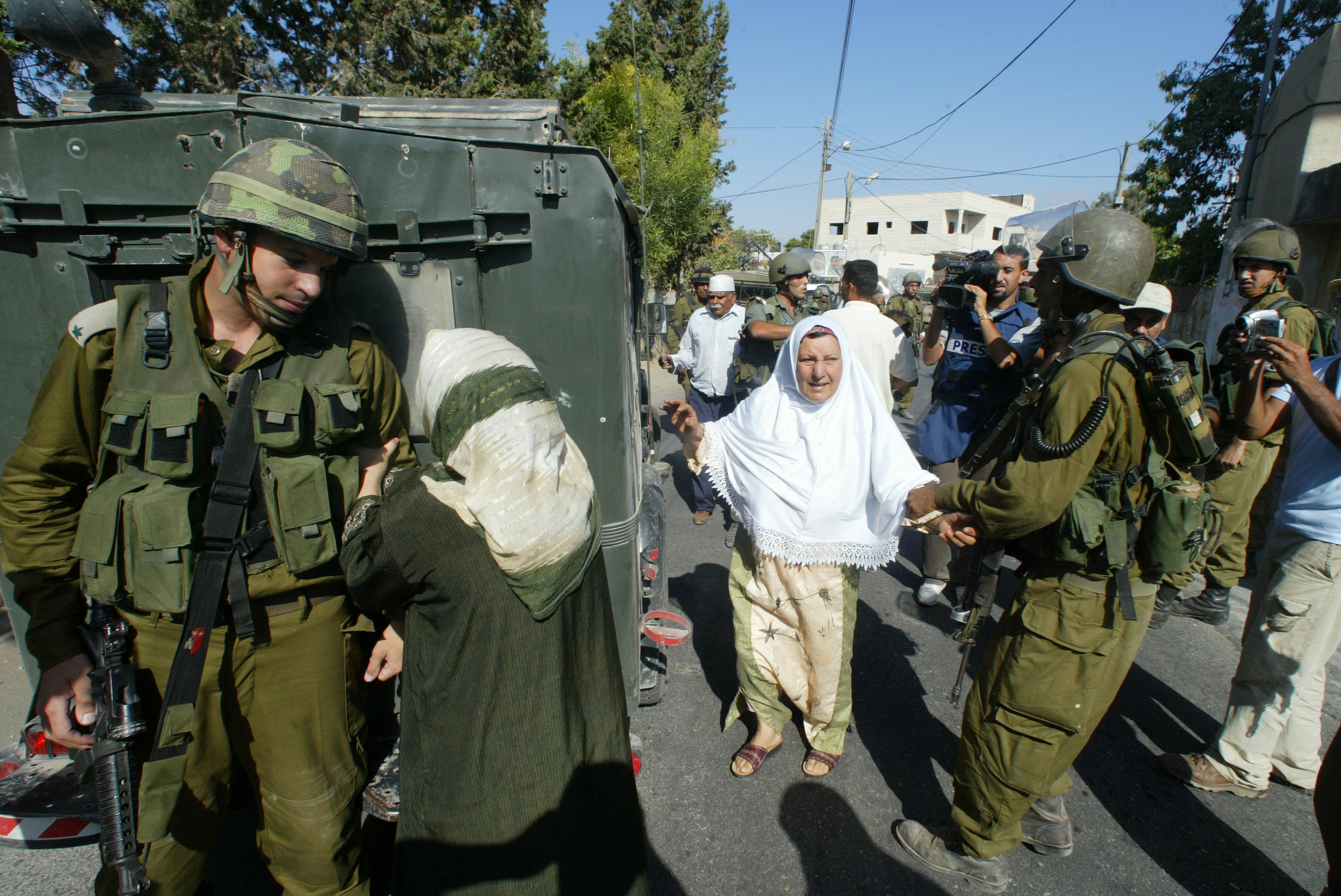 Still from 5 Broken Cameras. Scene shows the mother of a young man arrested by Israeli soldiers.