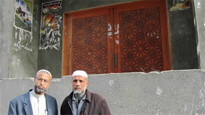 [Brothers Motee` (49) and Isma`il (53) as-Selawy in front of al-Maqadma mosque. Image from pchrgaza.org]