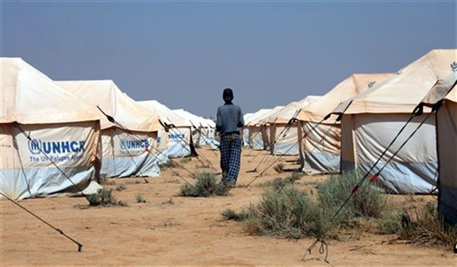 [A Jordanian works at setting up the first Jordanian tent camp for Syrian refugees in Zataari, Jordan, near the Syrian border, July 29, 2012. Image by Mohammad Hannon/AP Photo.]