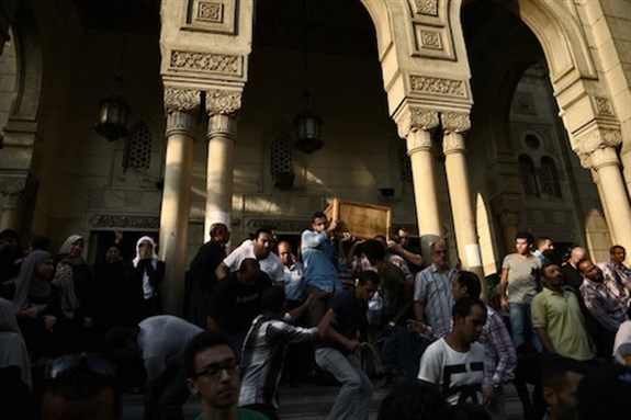 [Residents of al-Manial march from Salahuddien Mosque with the coffins of people killed in the clashes. 6 July 2013. Photo by Jonathan Rashad]