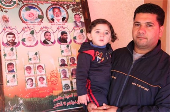 [Mohammed al-Dayrjah (thirty-one) with his daughter Qamar (one and a half). Image from pchrgaza.org.]