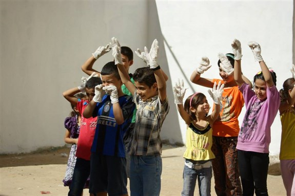 [Syrian children in Lebanon participate in a cleanup campaign with Basmeh & Zeitooneh aid organization. September 2013. From Basmeh and Zeitoonah Facebook page.]