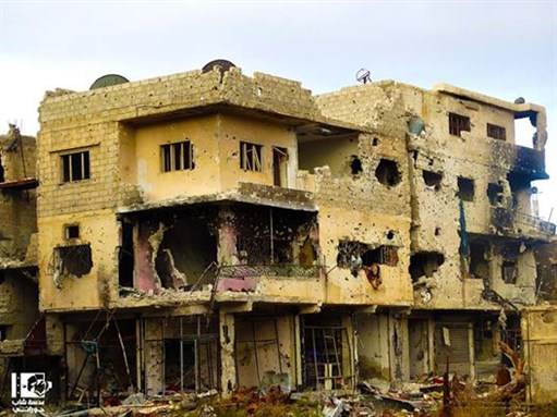 [Bullet-pocked buildings in Daraa City, in the south of Syria. 14 October 2014. From Lens Young Hourany.]