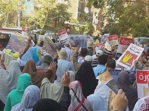 [Protesters marching to mark two years since the Rabea al-Adaweya square massacre. Photo from the official Facebook page of the Freedom and Justice Party.]