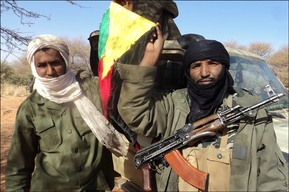 [Tuareg soldiers holding the flag of the National Movement for the Liberation of Azawad (MNLA). Image by Jemal Oumar/Magharebia.] 