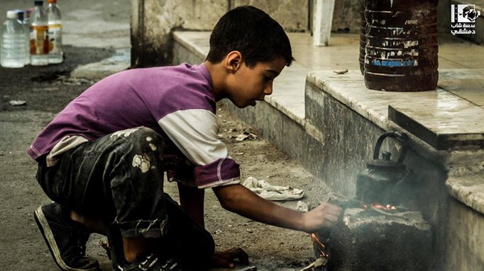 [A child makes tea in Ghouta, Damascus. 24 November 2013. From Lens of a Young Homsi.]