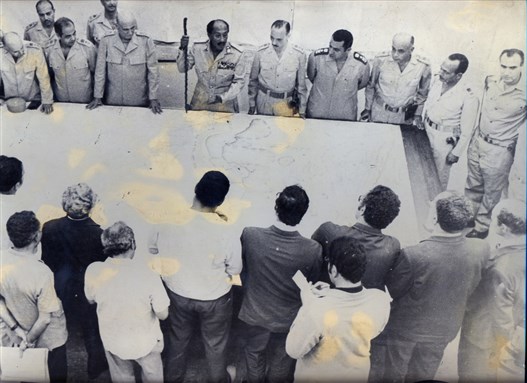 [Members of the Egyptian press listen to President Anwar Sadat and military commanders as they explain the course of the October 1973 War. Mubarak is fourth from the right. Image courtesy of Zeinab Mohamed.] 