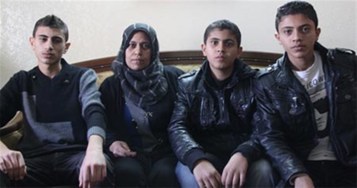 [Majda al-Nadeem with her sons Mohannad, Firas, and Bashar. Image from pchrgaza.org.]