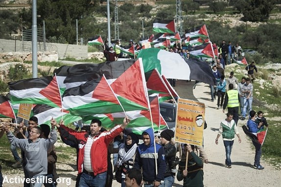 [Protest marking a decade to the struggle in Bil`in, West Bank, Friday 27 February 2015. Image by Activestills via Flickr]