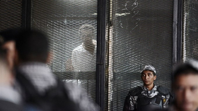 Photojournalist Mahmoud Abou Zeid is seen behind bars during a court hearing July 28, 2018. He is one of the more than 700 defendants in a political mass trial in Cairo for whom the 
