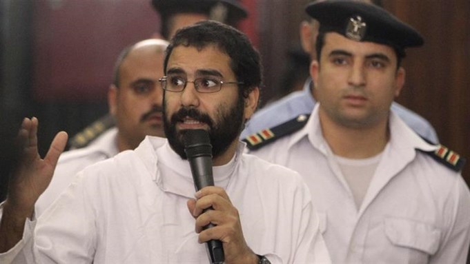 Activist Alaa Abdel Fattah speaks in front of a judge at a court during his trial in Cairo in 2014 [Via Reuters] 