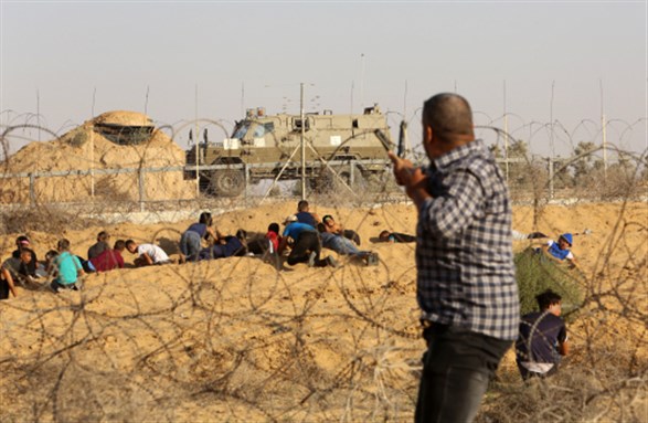Palestinian demonstrators clash with Israeli security forces during a protest along the border with Israel, eastern of Rafah, in the southern Gaza Strip, on August 16, 2019. Photo by Abed Rahim Khatib. Image via Shutterstock.