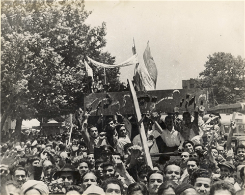 Protesters in Tehran removing the AIOC sign in 1951. Image provided by author via the BP archive.
