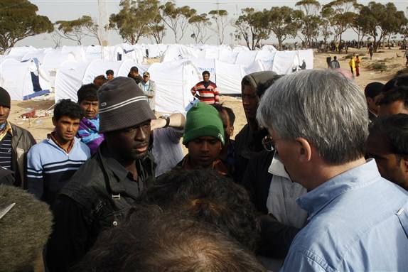 An image of migrants at a transit camp near the Tunisian border with Libya. Image by DFID - UK Department for International Development via Wikimedia Commons.