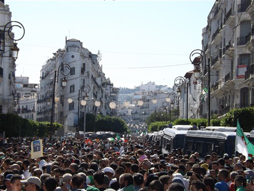 Algerians participate in huge demonstrations urging for the current regime's departure. (Algiers, Algeria; 4 October 2019). Image by drabotsmane via Shutterstock.