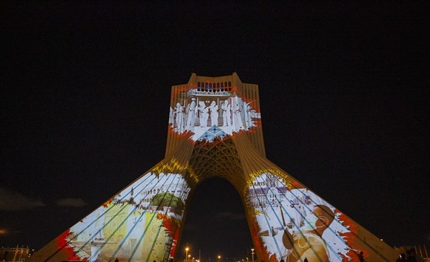 A projection on Azadi tower commemorating efforts to contain Covid-19. Image from Fars News Agency via Wikimedia Commons.