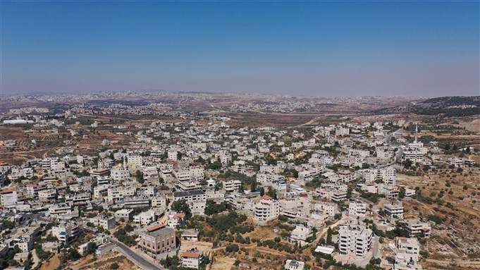 Palestinian Village Beit Surik with Jerusalem city in background Aerial view, Mosque, Jerusalem, August 2020 via Shutterstock