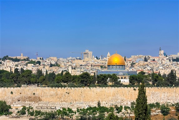 Jerusalem – July 15, 2010: A view of The Dome of the Rock with the wall around the Old City of Jerusalem via Shutterstock