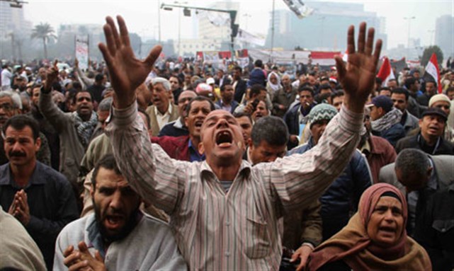 [Protesters chant slogans during a demonstration in Tahrir Square in Cairo, Egypt on Friday, 30 December 2011. Image from AP]