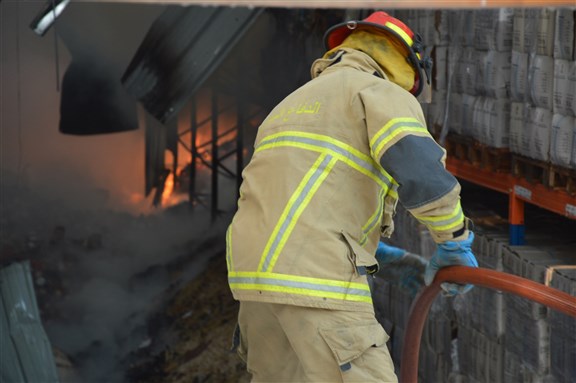 Beirut/Lebanon - September 10 2020: Lebanese Civil Defense firefighter try to extinguish a fire at Beirut's port via Shutterstock