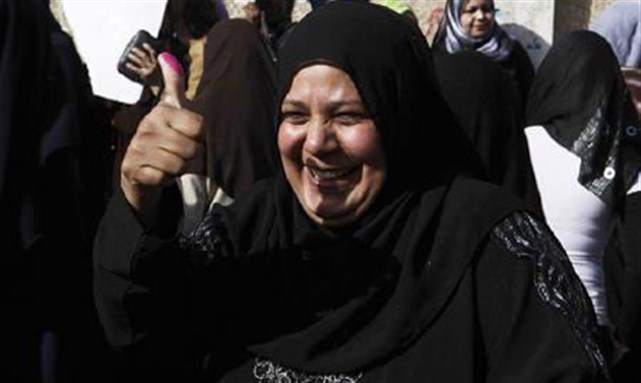 [ woman shows her inked finger after casting her vote in a constitution referendum at a school in Cairo, 19 March 2011. Image from Reuters]