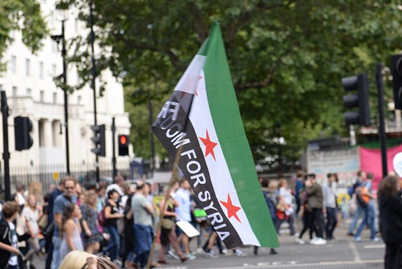 [Image of people in London standing in solidarity for Syrian refugees. Image by Ilias Bartolini via Flickr]