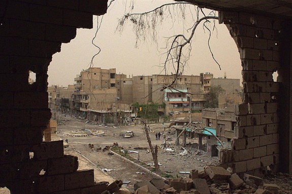 [Image of people walking down a street in Deir Ez-Zor. Image by Khalil Ashawi via Flickr]