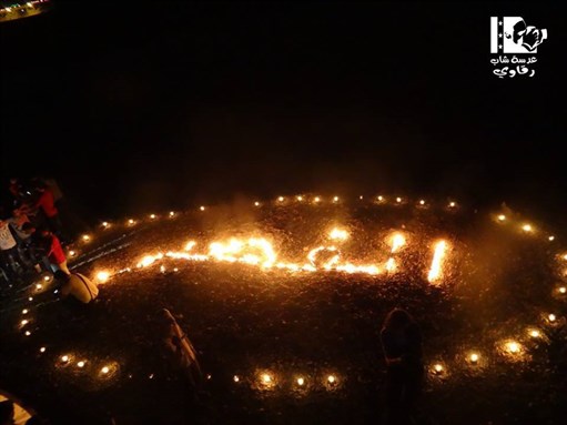 [\"Al-Qasayr.\" Candlelight vigil on the banks of the Euphrates River, Raqqa. 25 May 2013. From Lens of a Young Raqqaui.]