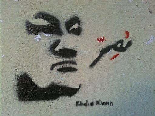 [2 February 2011, stencil of Mubarak on a wall in Tahrir Square. Original artwork by Sudanese cartoonist Khalid Albaih. Photo by Khalid Albaih via Flickr]