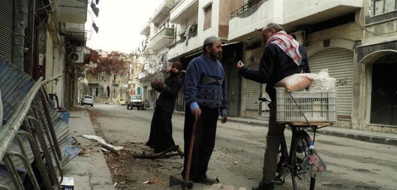[An old man and old woman who cut wood for use in heating and cooking in Homs city. Boustan al-Dewan. 27 November 2012. Via Lens Young Homsi.] 