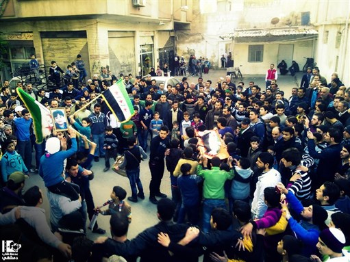 [Friends of Aiman Al Hamwe mourn at his funeral. Jobar, Damascus. 19 December 2012. Via Lens Young Dimashqi.]