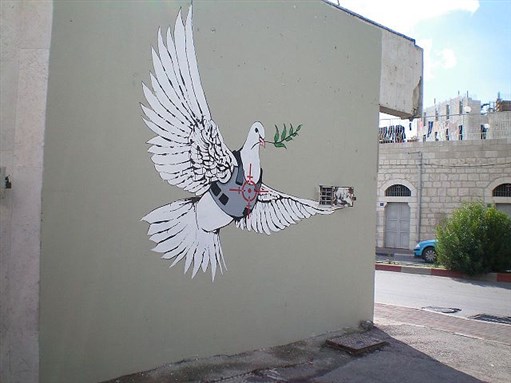 [Banksy`s Armoured Peace Dove, West Bank, Palestine, 2007. Image by eddiedangerous on Flickr.]