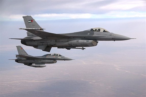 [Royal Jordanian Air Force F-16 Fighting Falcon aircrafts fly alongside a US Air Force KC-135 Stratotanker aircraft while waiting to connect for fuel over Jordan on 19 October 2009.]