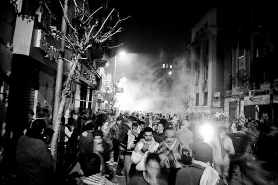 [4 February 2012, protesters escaping tear gas at Mohamed Mahmoud Street. Photo by Hossam al-Hamalawy via Flickr]