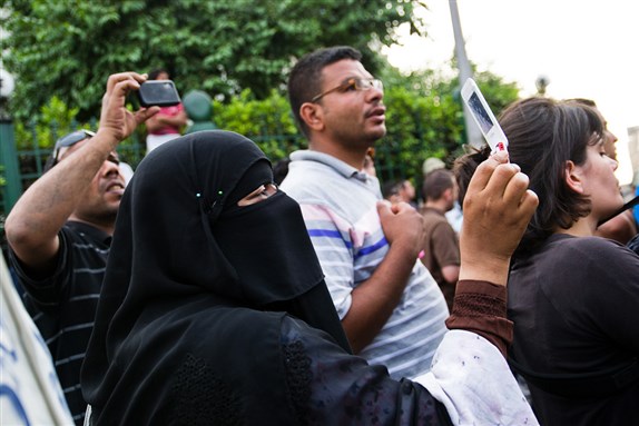 [The crowd captures images as the protestors and military clash at Abbasiya. Image from Flickr.]