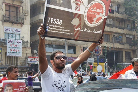 [Supporters celebrate Mohamed Morsi`s initial victory in the Egyptian presidential elections. Image originally posted to Flickr by Zeinab Mohamed.]