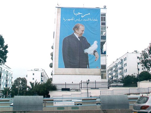 [A poster of Algerian president Abdelaziz Bouteflika in Algiers, Algeria. Image from Wikimedia Commons.]