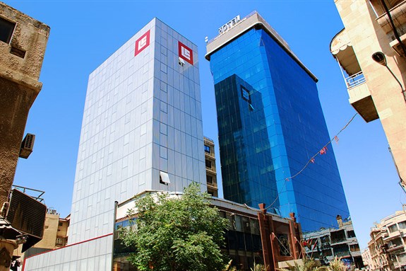 [Bank Al-Sharq (Banque Libano-Française Group) and the Blue Tower Hotel in Damascus, Syria. Image from Wikipedia.]