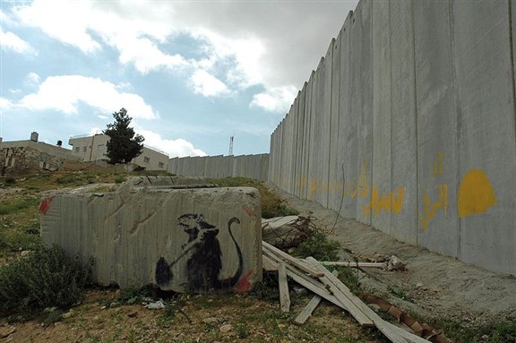 [Banksy \"Rat and Wall\" at Al Quds University in Jerusalem. Photo by Peter Mulligan, Wikimedia Commons]