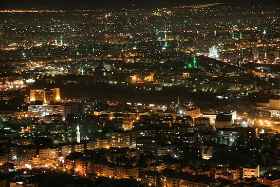 [Damascus at night. Image from Wikimedia Commons.]