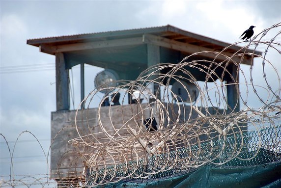 [GUANTANAMO BAY, Cuba - A guard stands duty in a tower over Camp Delta Sept. 12, 2007. Image by by Army Sgt. Joseph Scozzari.]