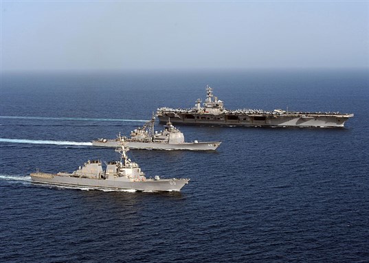 [US Naval Vessels in Formation in the Arabian Sea. Image from Wikimedia Commons.]