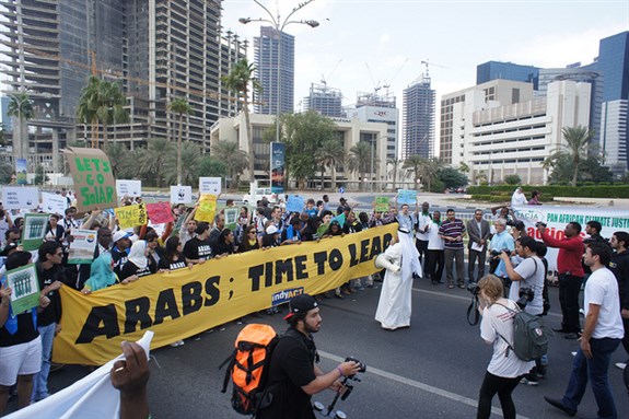 [Climate activists gathered for a march on the waterfront in Doha; calling on Arab countries to take the lead in UN climate change negotiations, Saturday 1 December 2012. Image from Flickr/adopt a negotiator]