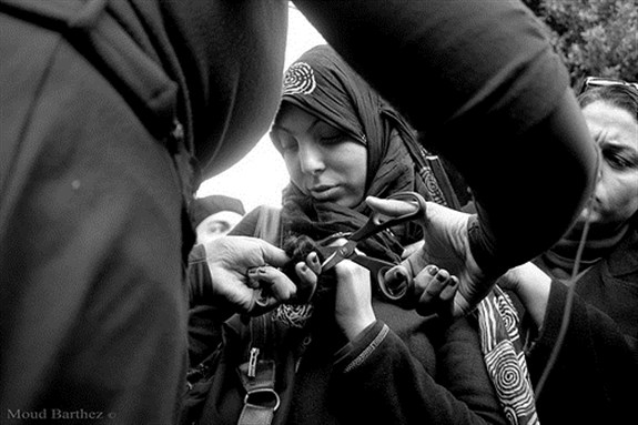 [Egyptian women cut their hair in Tahrir Square to protest fundamentalist constitution. Image originally posted to Flickr by Moud Barthez.]