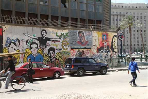[Wall graffiti in Tahrir Square. Image originally posted to Flickr by \"Travel Aficionado.