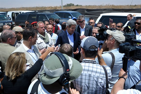 U.S. Secretary of State John Kerry speaks to a crowd of reporters as he concludes his visit to the Za`atri camp for Syrian refugees in Jordan on July 18, 2013. Image by US Department of State.]