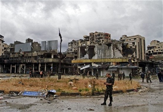 [The Syrian army patrols a part of Homs on Thursday 8 May 2014, a day after opposition fighters evacuated the city as part of their agreement with the Syrian regime. Image via Associated Press]