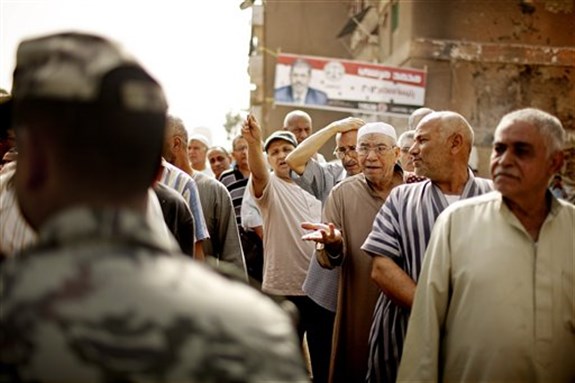 [Egyptian voters argue with a solider as they wait cast ballots in Basateen a southern suburb of Cario, Egypt on May 23, 2012. Image by Pete Muller/AP Photo.]