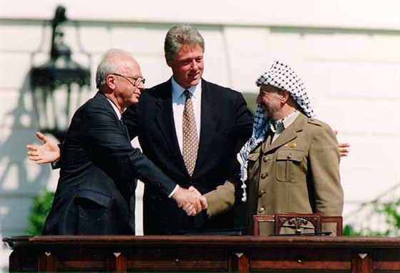 [Yitzhak Rabin, Bill Clinton, and Yasser Arafat at the Oslo Accords signing ceremony on 13 September 1993. Image by Vince Musi/The White House.]