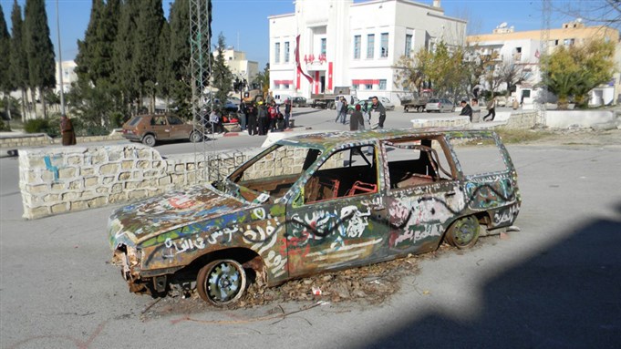 [Burnt car on the streets of Le Kef. Image by Laryssa Chomiak and Jillian Schwedler.]